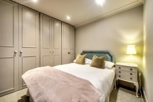 a bedroom with a large bed with a blue headboard at Hamilton Place - Beautiful and central city apartment with private entrance sleeps 4 in Edinburgh