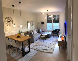 a living room with a couch and a table at Apartment Starlight Bjelašnica in Bjelašnica