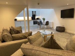 a living room with a couch and a table at King Street Serviced Apartments in Lancaster