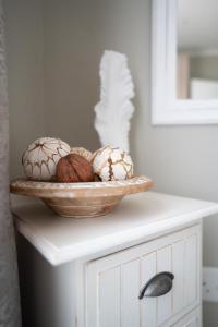 a table with a bowl of balls of yarn on it at Lalata House in Northwold
