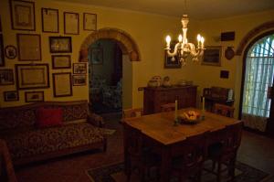 a living room with a table and a couch at Agriturismo La Leccia in Bibbona
