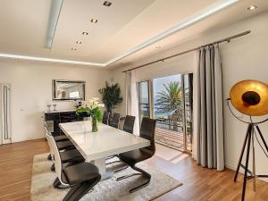 a dining room with a white table and chairs at Villa Prainha by LovelyStay in Caniçal