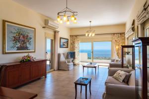 a living room with a couch and a table at Votana Villa & Apartments in Koutsounari