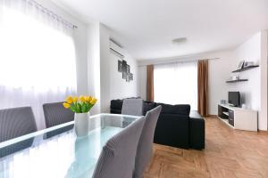 a living room with a glass table and chairs at Apartments Villa Visnjik in Zadar