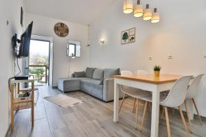 a living room with a table and a couch at Casa do Loureiro 1 - Seia - Serra da Estrela in Seia