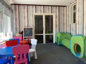 a room with colorful chairs and a table at Belvederská chalupa in Železná Ruda