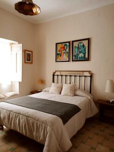 a bedroom with a large bed with two pillows at La Casa De Las Bicicletas in Cazorla