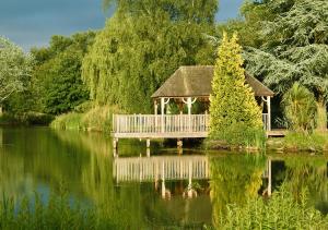 a gazebo sitting on top of a lake at Cadnam Lodge in Cadnam