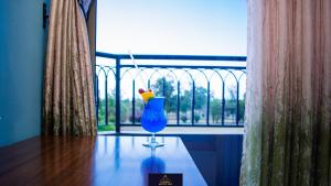 a blue glass sitting on a table in front of a window at HOTEL TAJI in Nanyuki