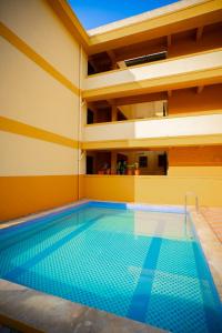a pool in a building with a swimming pool at Field stone Apartment in Varca