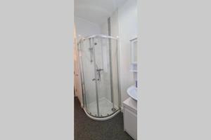 a bathroom with a glass shower in a room at Peninsula Pad in Portrush