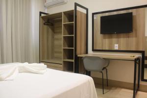 Postel nebo postele na pokoji v ubytování Hotel Oscar Gold Janaúba + 16 fotografií