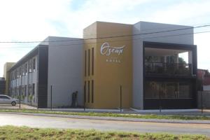 a large building with a sign on the side of it at Hotel Oscar Gold Janaúba in Janaúba