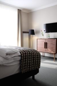 Postel nebo postele na pokoji v ubytování Parkhotel Obermenzing