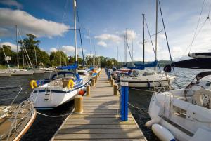 a bunch of boats are docked at a dock at Ivythwaite Cottages in Windermere