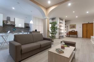 ein Wohnzimmer mit einem Sofa und einem Tisch in der Unterkunft Casa Vacanze Aurora in Fiumicino