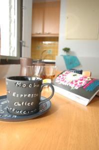 a coffee cup on a table next to a cake at Rangsit Apartment I in Ban Talat Rangsit