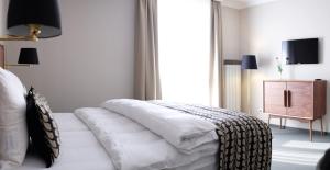 Postel nebo postele na pokoji v ubytování Parkhotel Obermenzing