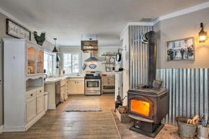 a kitchen with a stove in the middle of it at Modern Farmhouse with Movie Room - 6 Mi to Lake! in Coeur d'Alene