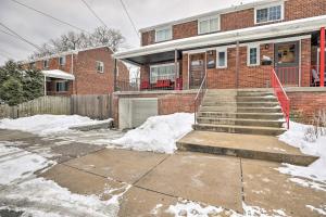 a brick house with snow in front of it at Pittsburgh Townhome about 5 Miles to Market Square in Pittsburgh