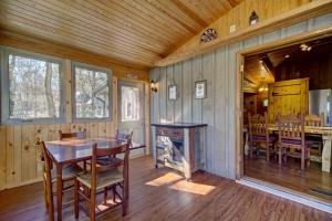 a dining room with a table and a fireplace at Cozy Log Cabin 6 Mi to Great Smoky Mtns NP! in Townsend