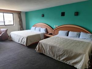 A bed or beds in a room at Hotel Puerta del Sol