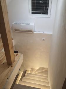 a stairs in a room with a air conditioner at Kucica u Šumi in Užice