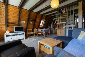 un salon avec un canapé bleu et une table dans l'établissement Ferienwohnpark Immenstaad am Bodensee Nurdachhaus Typ 7 ND 48, à Immenstaad am Bodensee