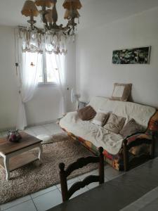 a bedroom with a bed and a table in it at Nid douillet au calme in Larche +19 photos