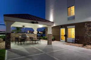 a patio with tables and chairs in a house at Candlewood Suites Loveland, an IHG Hotel in Loveland