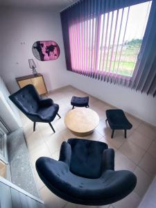 a living room with two chairs and a table at Best Western Hotel & SPA Pau Lescar Aeroport in Lescar