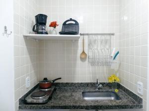 a kitchen counter with a sink and a stove at Viva Buzios in Búzios +59 photos
