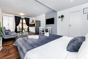 a bedroom with a large bed and a living room at Deluxe Apartments A&A in Rovinj