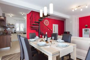 a dining room with a table and a red wall at Villa Lavandula in Tribalj