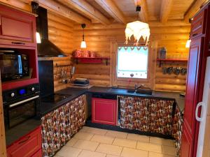 a kitchen with a stove and a sink in a cabin at Chalet de charme authentique in Bolquere Pyrenees 2000