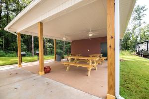a pavilion with a picnic table and benches on it at Savannah Suites Atlanta Airport in Atlanta