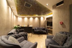 a living room with a couch and chairs and a table at World Heritage Center Hotel in Istanbul