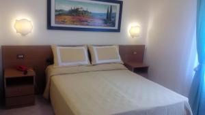 Postel nebo postele na pokoji v ubytování Hotel Astor Victoria