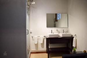 a bathroom with two sinks and a mirror at Quinta Alhóndiga Galindo Hotel Boutique in Cholula +45 photos
