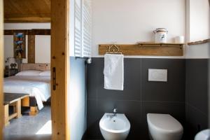 a bathroom with a sink and a toilet and a bed at B&B Il Cavallino in Civitanova Alta +124 photos