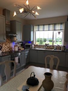 a kitchen with a table with a tea kettle on it at Broomfields in Greenane