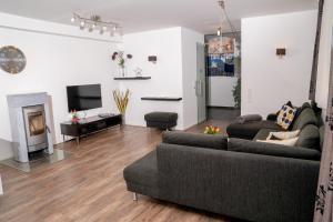 a living room with a couch and a fireplace at Apartment Jessica in Leogang