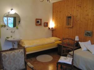 a bedroom with two beds and a sink and a mirror at Chez Jean et Daisy in Basel