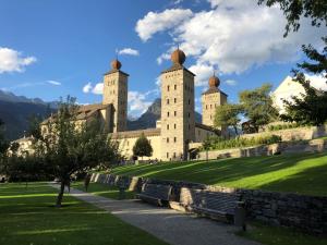 a castle with two towers on top of a hill at Zimmervermietung Ackersand in Stalden