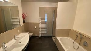 a bathroom with two sinks and a shower and a toilet at Apartment Jessica in Leogang +21 photos