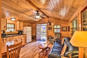 a kitchen and living room in a log cabin at Cozy Anchors Away Cabin Hideaway with Fire Pit! in Parsons