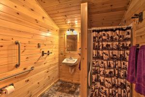 a wooden bathroom with a sink and a mirror at Cozy Anchors Away Cabin Hideaway with Fire Pit! in Parsons