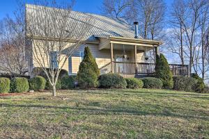 a house with a porch and bushes in front of it at Secluded Hilltop Columbia Home with Deck and Views! in Columbia