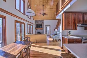 a kitchen and dining room with a wooden table at Secluded Hilltop Columbia Home with Deck and Views! in Columbia