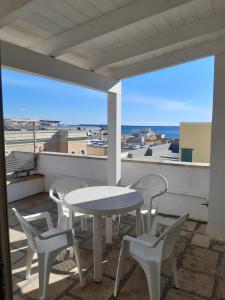 a white table and chairs on a balcony with a view at Gallipoli centro in Gallipoli